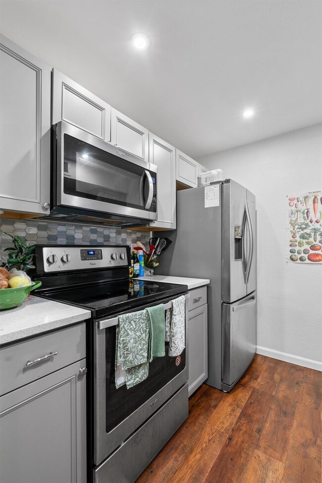 Kitchen featuring dark wood-style flooring, gray 