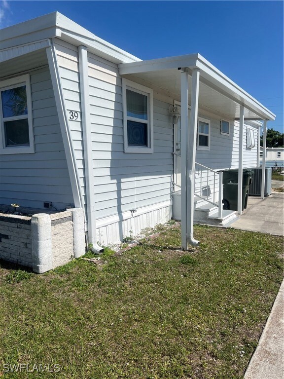 View of side of property with a lawn