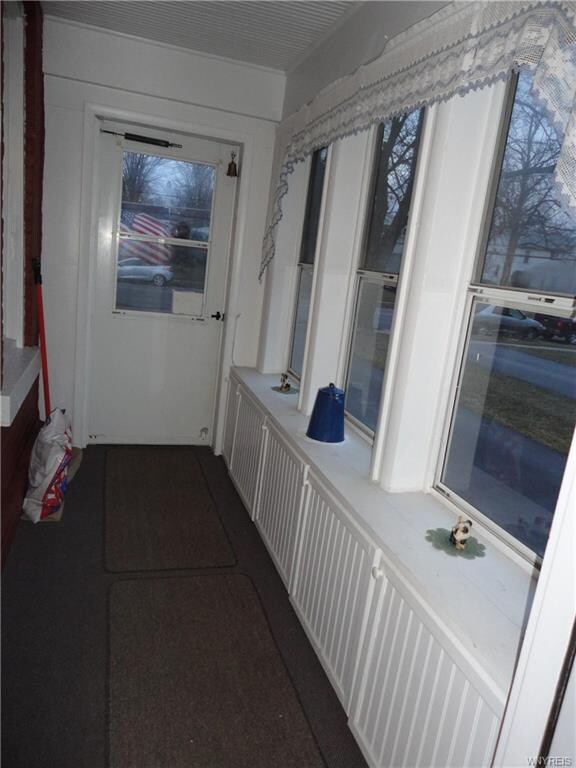 Side sun porch entrance has BI storage cupboards