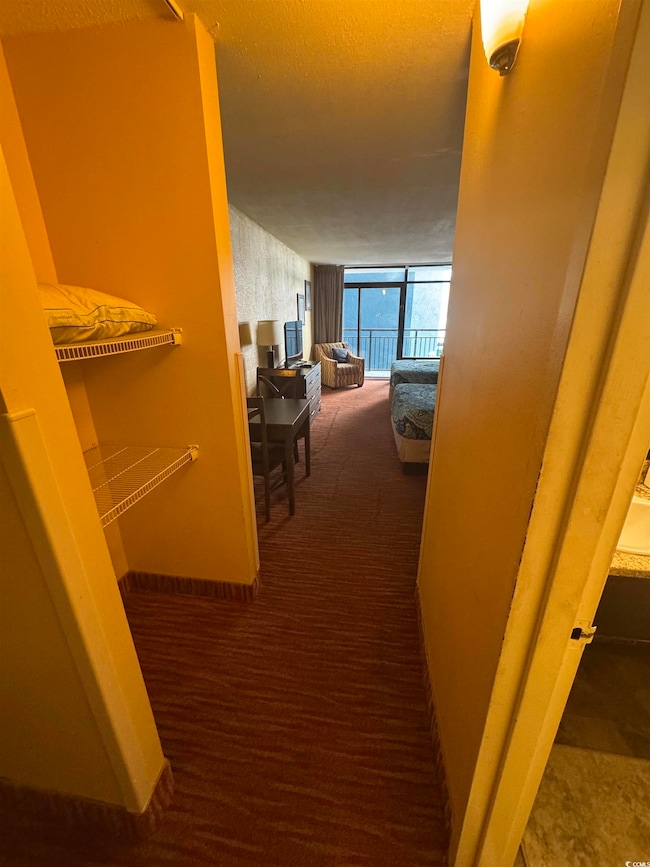 Corridor featuring carpet