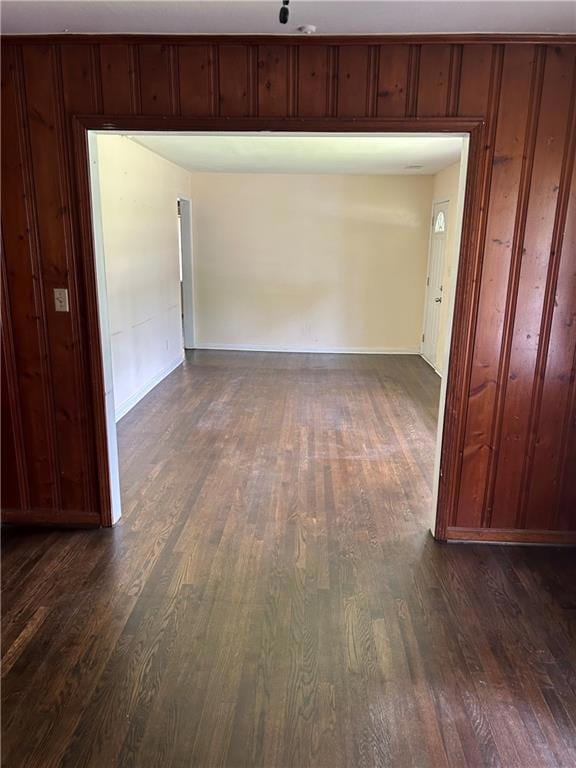 Empty room featuring dark wood finished floors