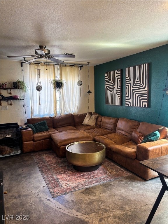 Living room with a ceiling fan, concrete flooring,