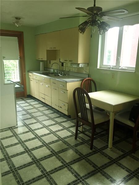 Kitchen w back door that opens to porch w an amazi