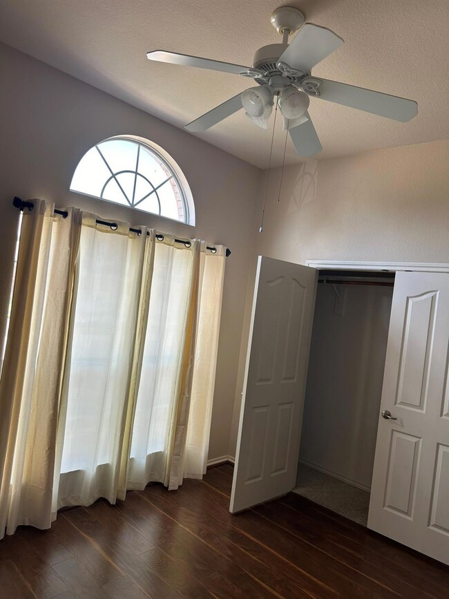 Unfurnished bedroom with wood-type flooring, a clo