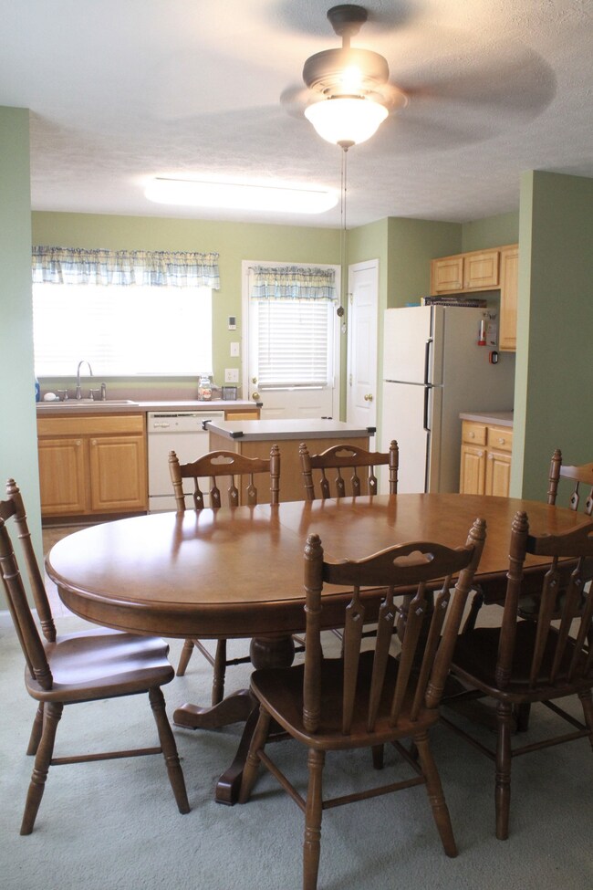 Another view of dining room & kitchen.