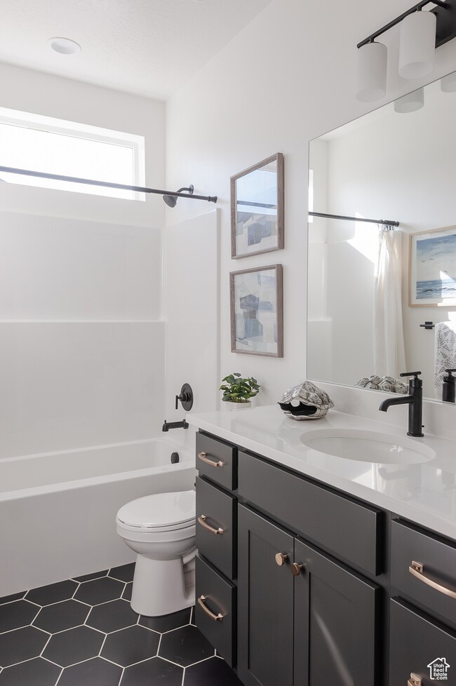 Bathroom featuring vanity and shower / bath combo