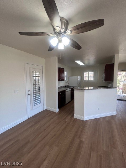 Kitchen featuring ceiling fan, dishwasher, a penin