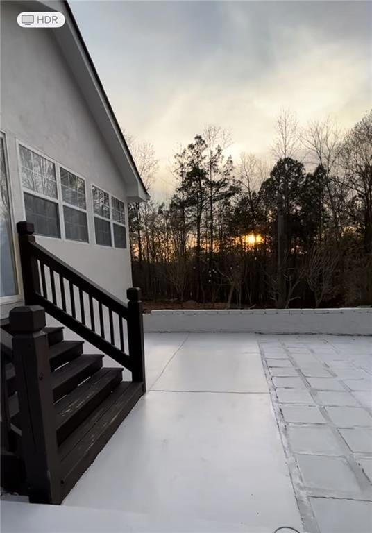 Huge concrete patio with stone fire pit.