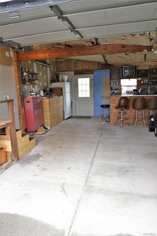 Attached garage, man cave to the rear with beer fr