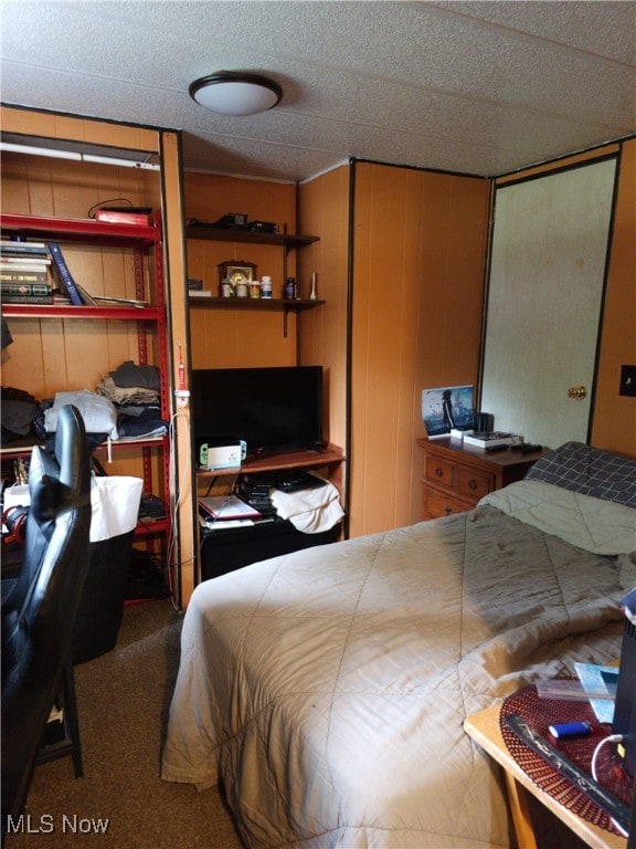 Bedroom with dark carpet and a closet