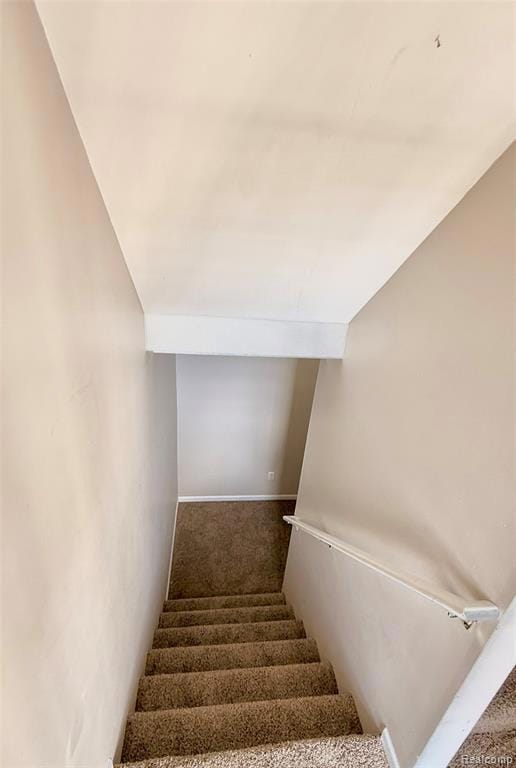Stairway with carpet flooring and baseboards