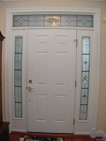 Custom made beveled & leaded glass surround the fr