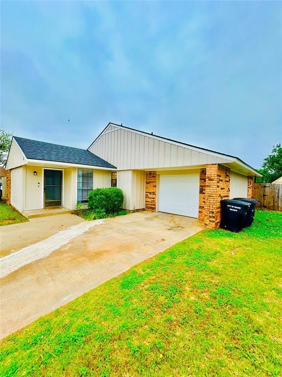 View of front of house featuring concrete driveway and a garage