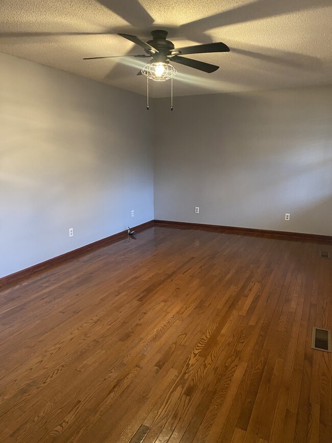 You enter this home into the large living room with gorgeous hardwood floors.