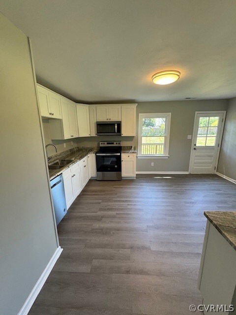 Kitchen with dark hardwood / wood-style flooring,
