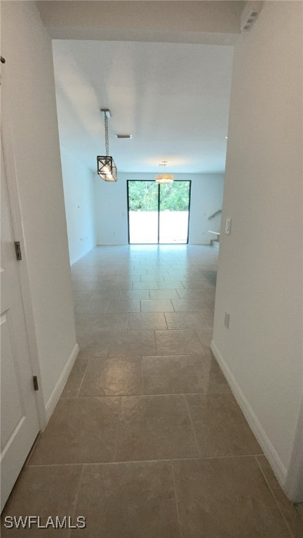Corridor featuring baseboards