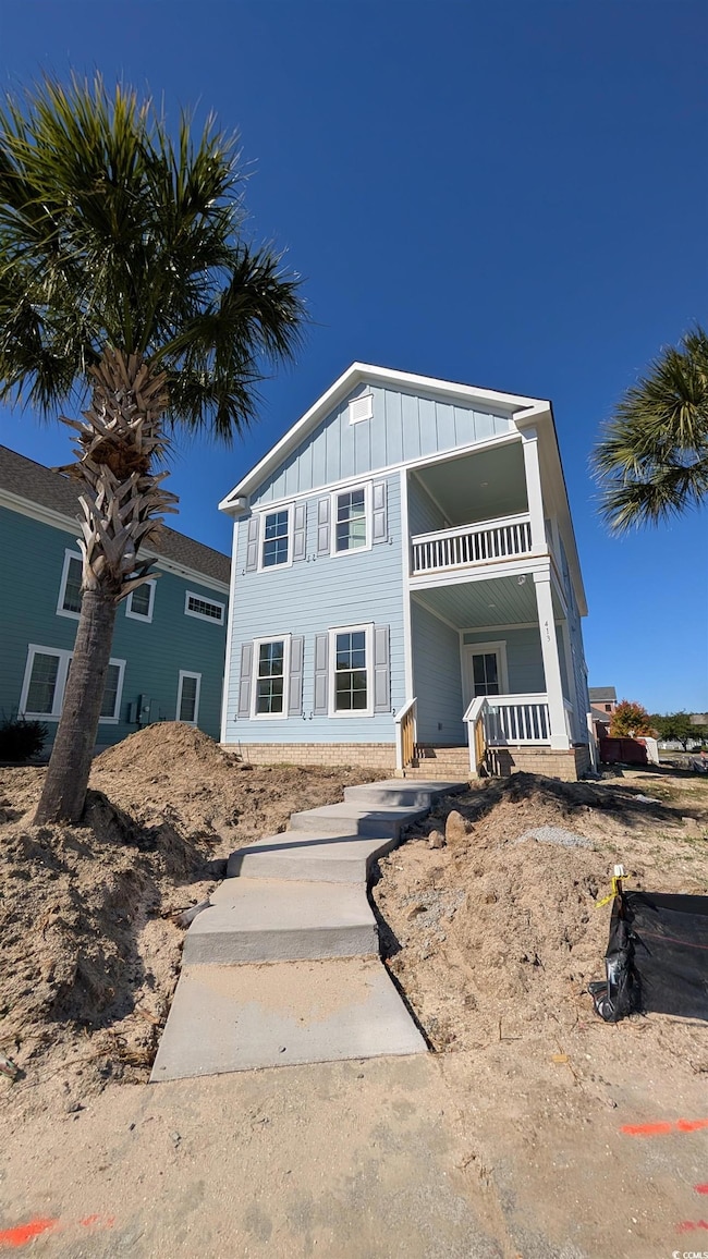 View of front of property featuring board and batten siding and a balcony
