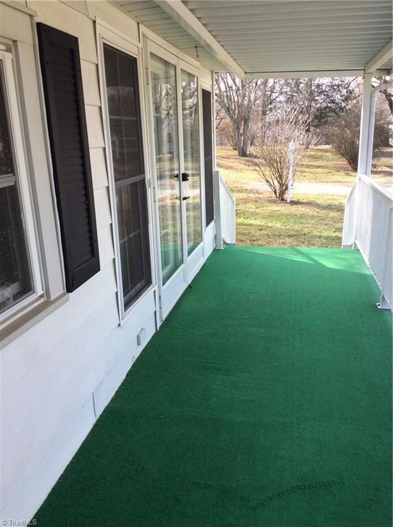 Front Porch looking out to the front yard. Extra parking spot just beyond the white lamp post.