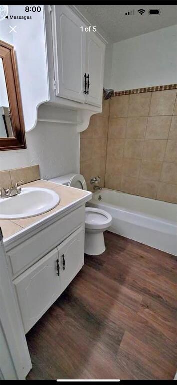 Full bathroom with hardwood / wood-style flooring,