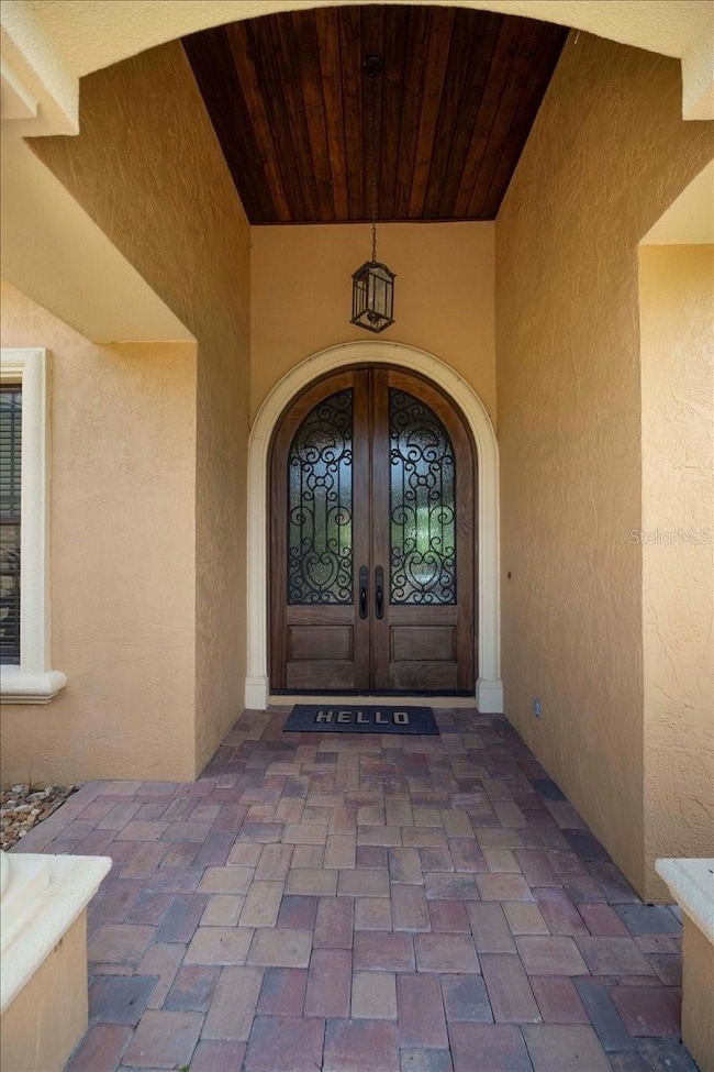 Arched iron and glass doors welcome you home.