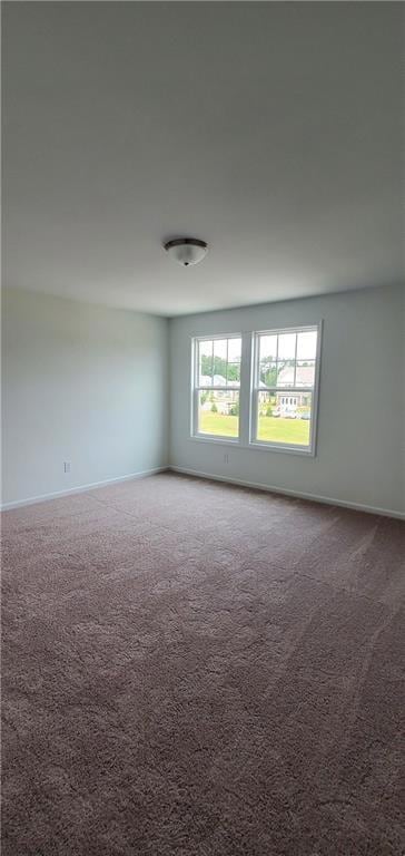 Carpeted empty room with baseboards