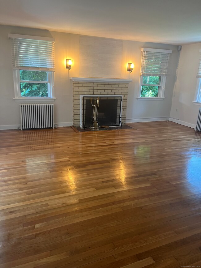 The living room is very spacious and offers hardwo
