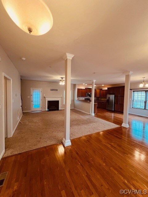 Unfurnished living room with dark hardwood / wood-