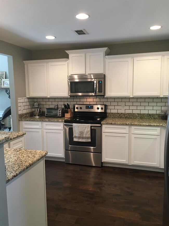 Attractive staggered white cabinets, granite counter tops, back splash and stainless steel appliances!