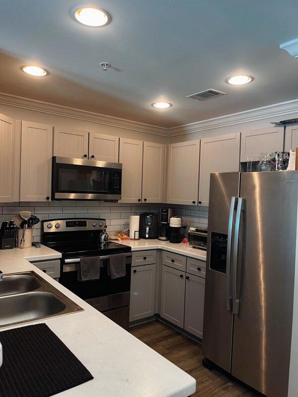 Kitchen with stainless steel appliances, decorati