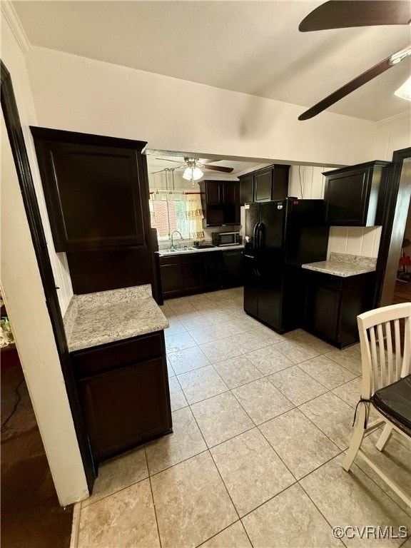 Kitchen featuring light stone countertops, light t