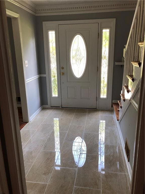 Foyer with light marble finish floors and stairway