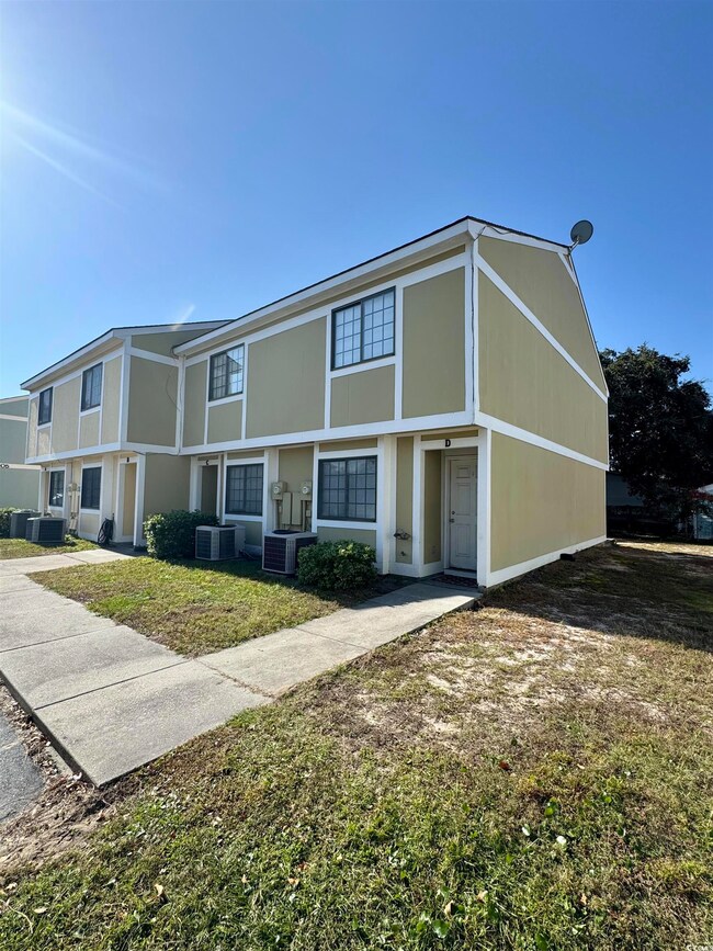 Tudor-style house with a front lawn