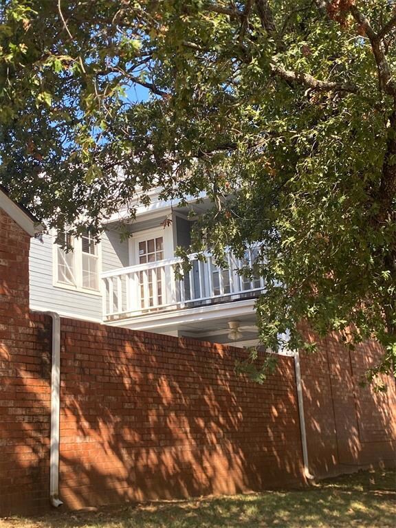Side view of property with a master bedroom balcon