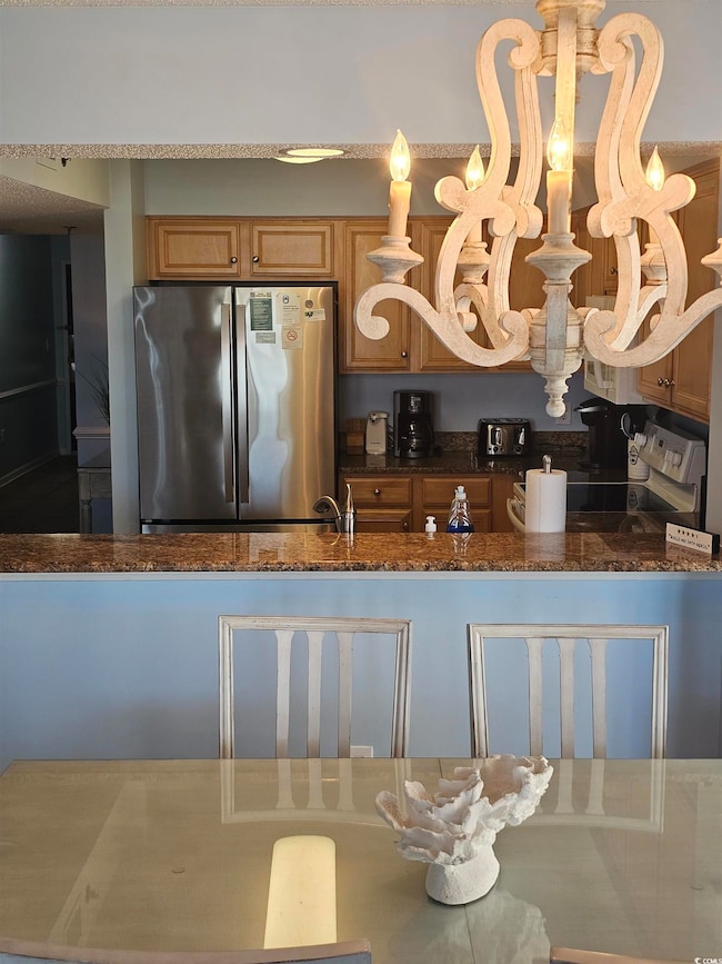 Kitchen with freestanding refrigerator and Granite  counters Tops