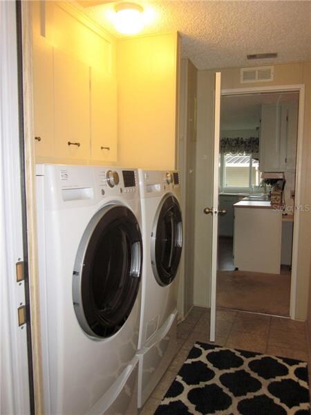 Inside utility room with upgraded washer and dryer