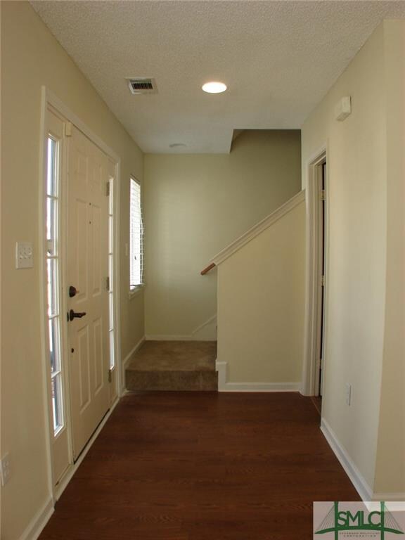 Foyer has wood look vinyl flooring