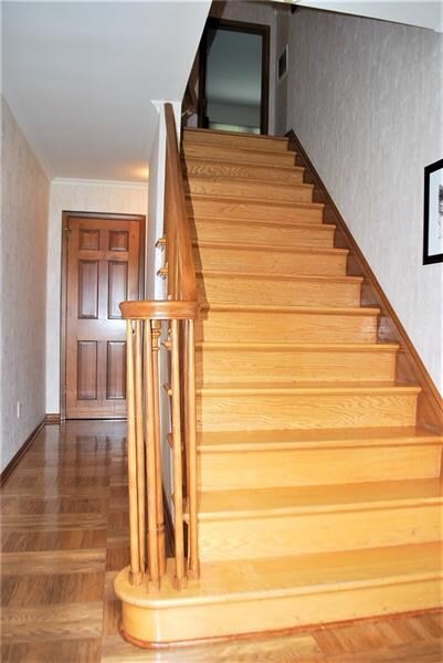 Attractive entry way boasting parquet flooring and hardwood steps to upper level!