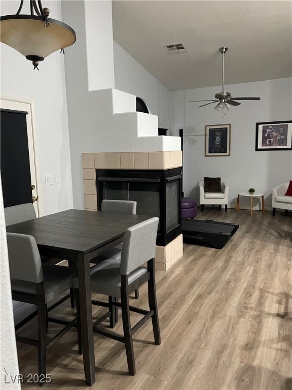 Dining space with a fireplace, light wood-type flo