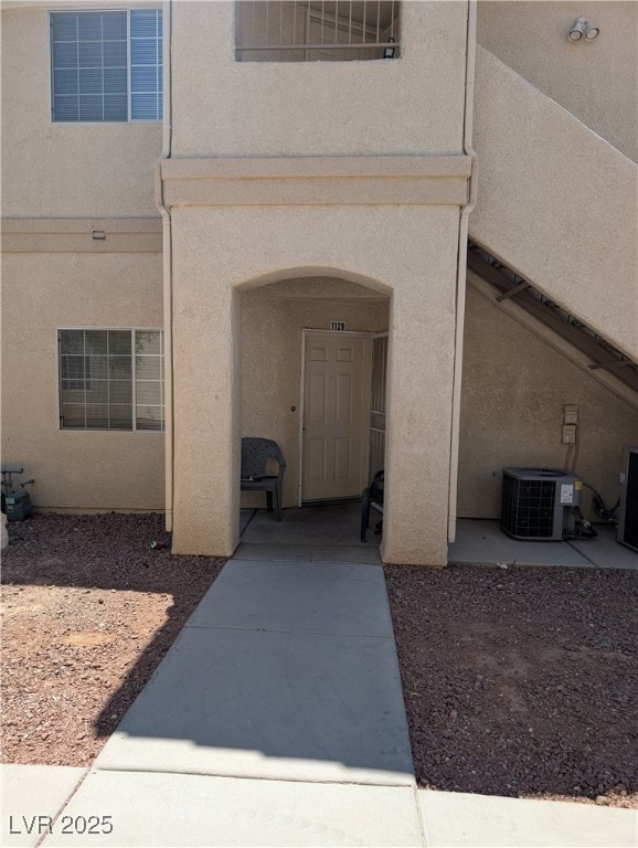 View of exterior entry featuring stucco siding