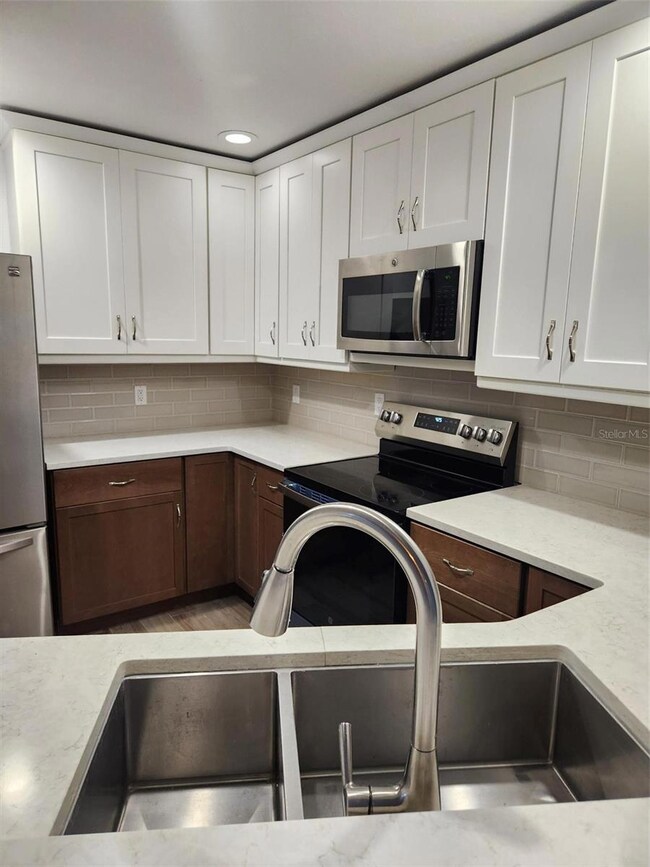 Quartz counters and tile backsplash