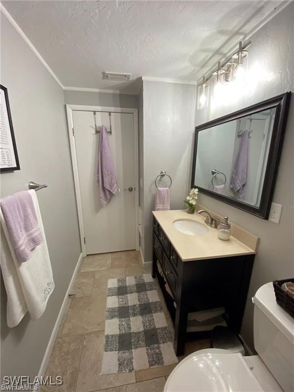 Bathroom with vanity, a textured ceiling, toilet,