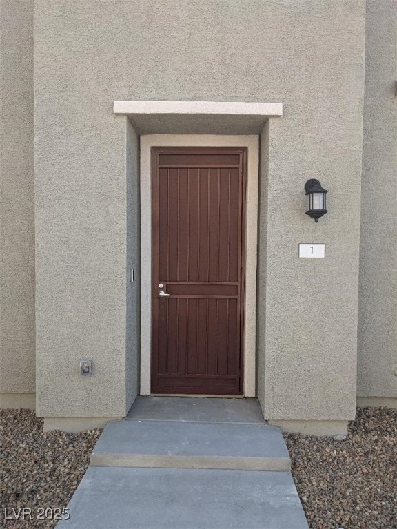 Property entrance with stucco siding