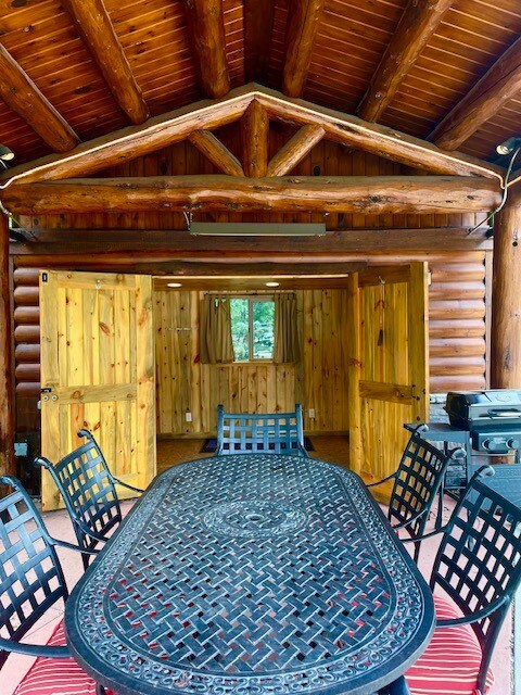 Underneath picnic shelter and view into shed