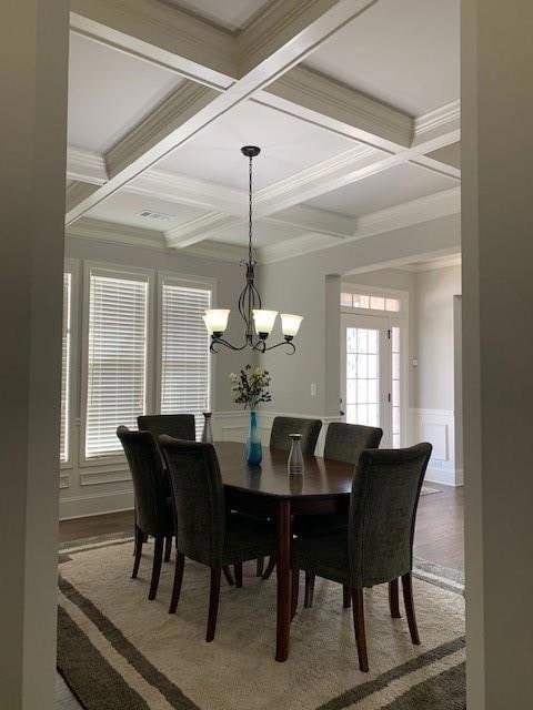 Dining space featuring beamed ceiling, ornamental 