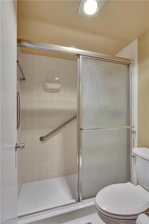 Main Bathroom featuring a stall shower and toilet.