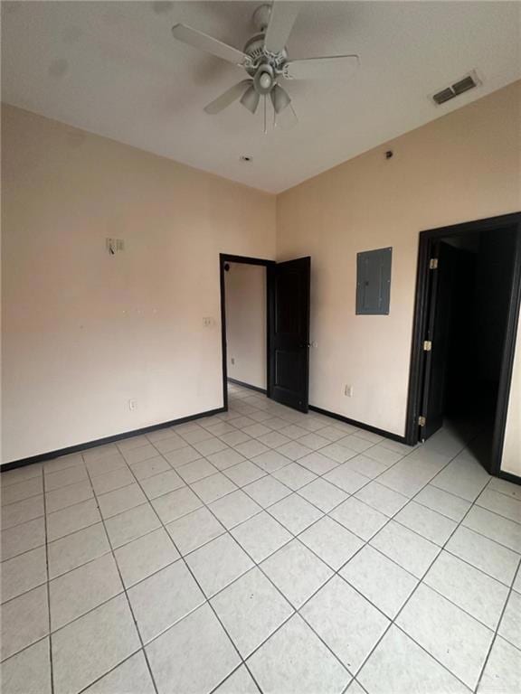 Unfurnished room featuring electric panel, ceiling fan, and light tile patterned floors