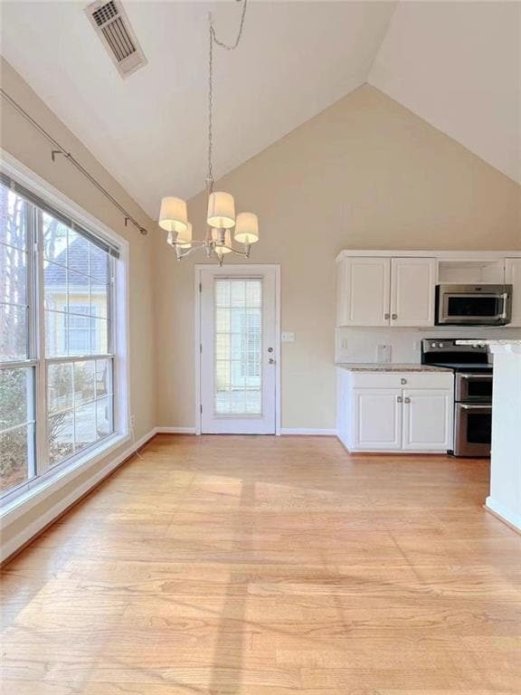 Kitchen with visible vents, a notable chandelier, 
