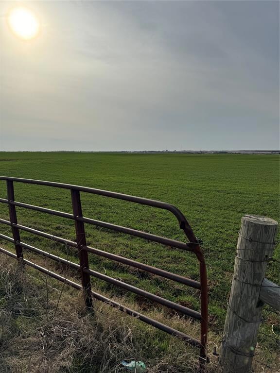 View of gate featuring a yard and a rural view