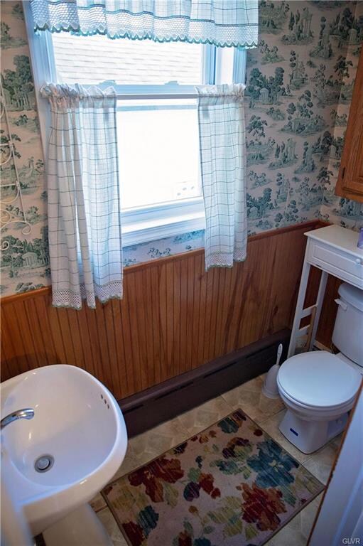 Powder room with wainscoting off kitchen