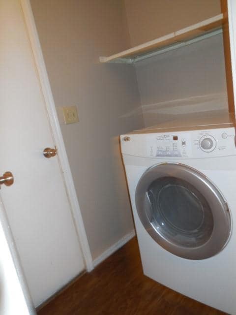 Clothes washing area with washer / dryer and dark 
